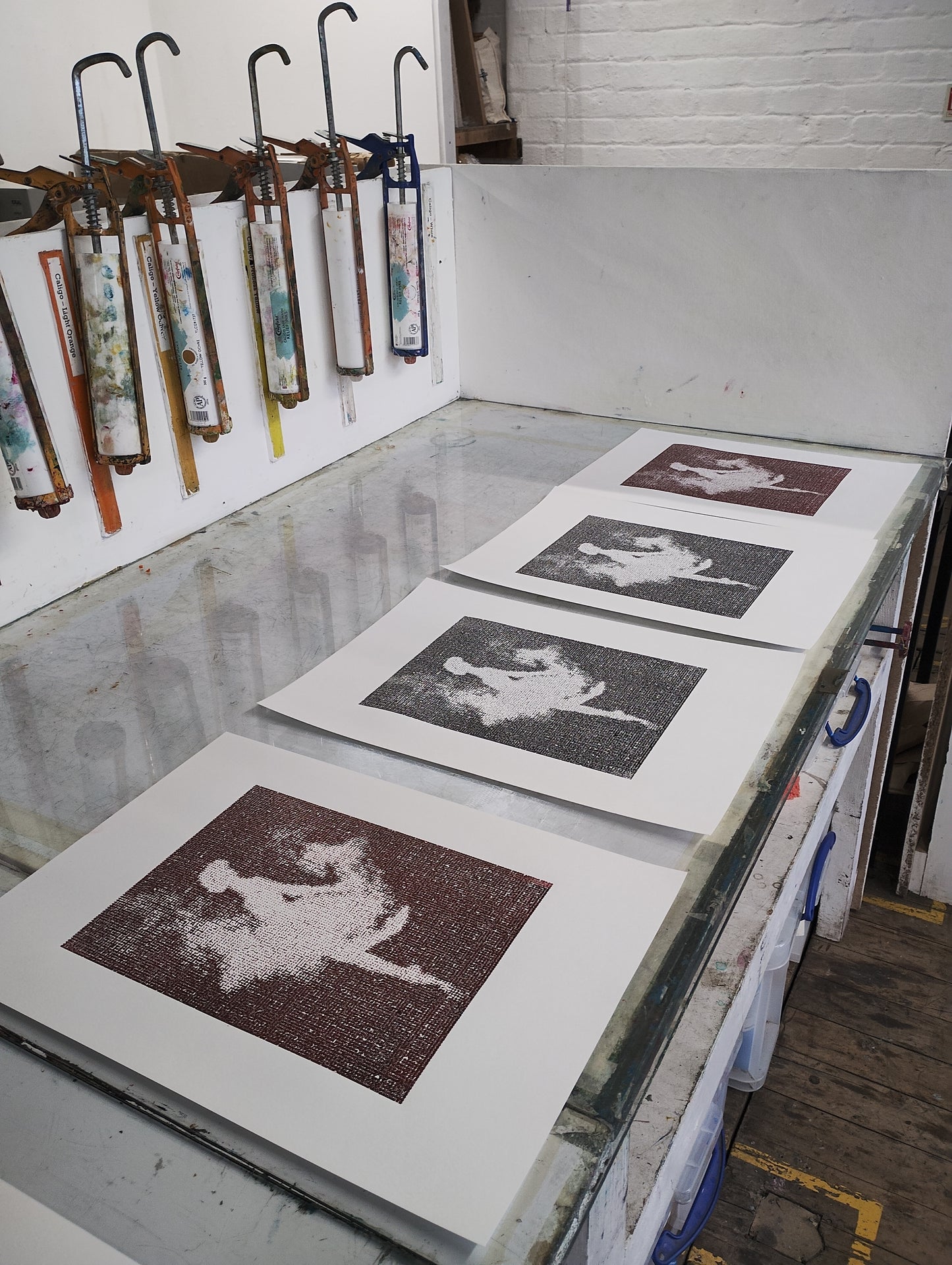 Artistic prints of a horse on display with various tools and materials in the background by Guido Salimbeni
