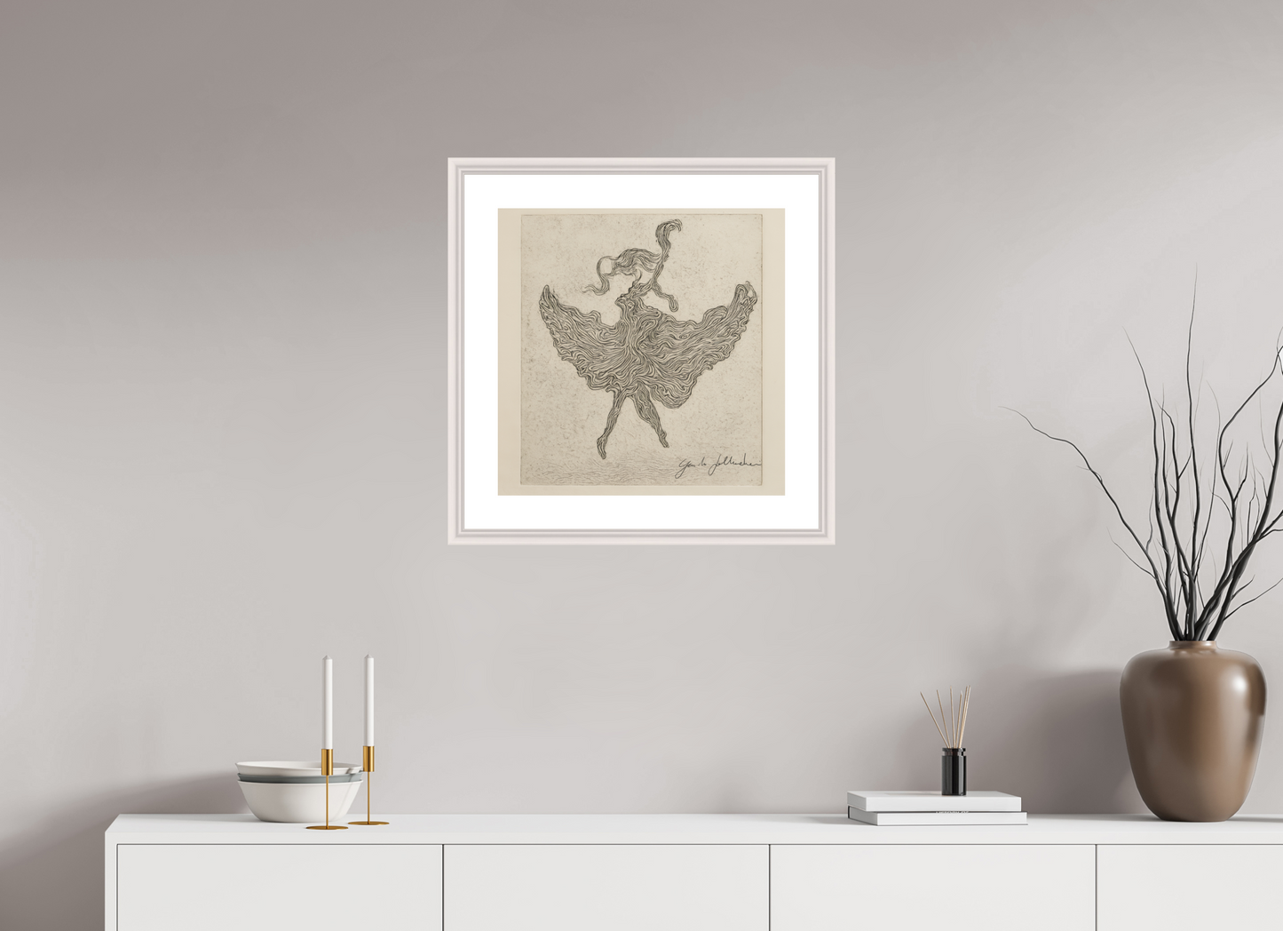 Framed artwork of a dancer on a neutral wall above a white cabinet with decorative items.